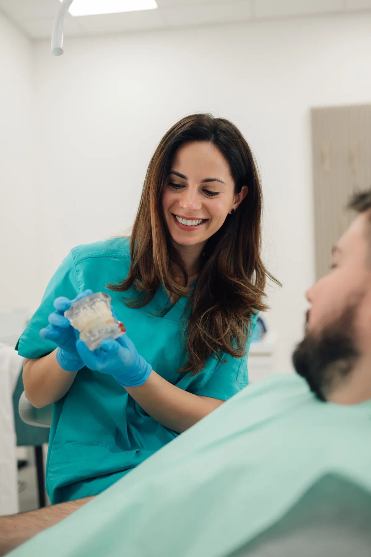 Oral surgery team member reviewing a treatment plan chairside with a patient