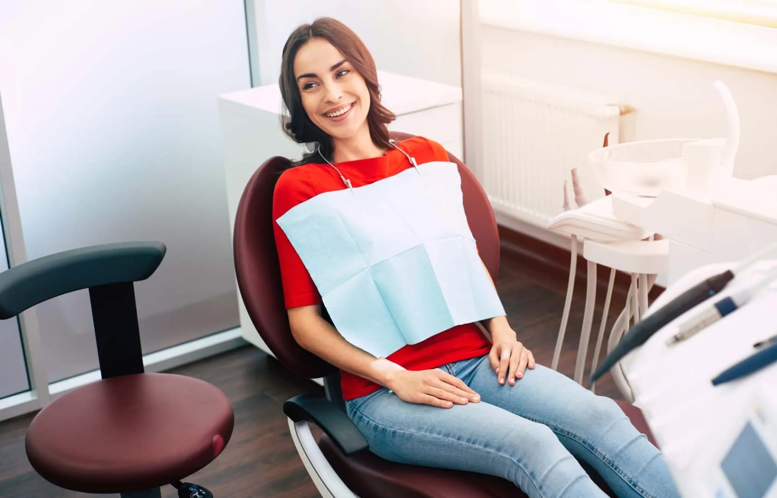 Relaxed oral surgery patient smiling in the dental chair