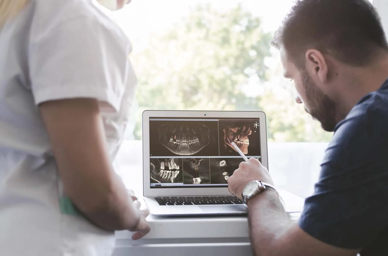 Patient reviewing wisdom teeth removal costs and insurance options during a consultation