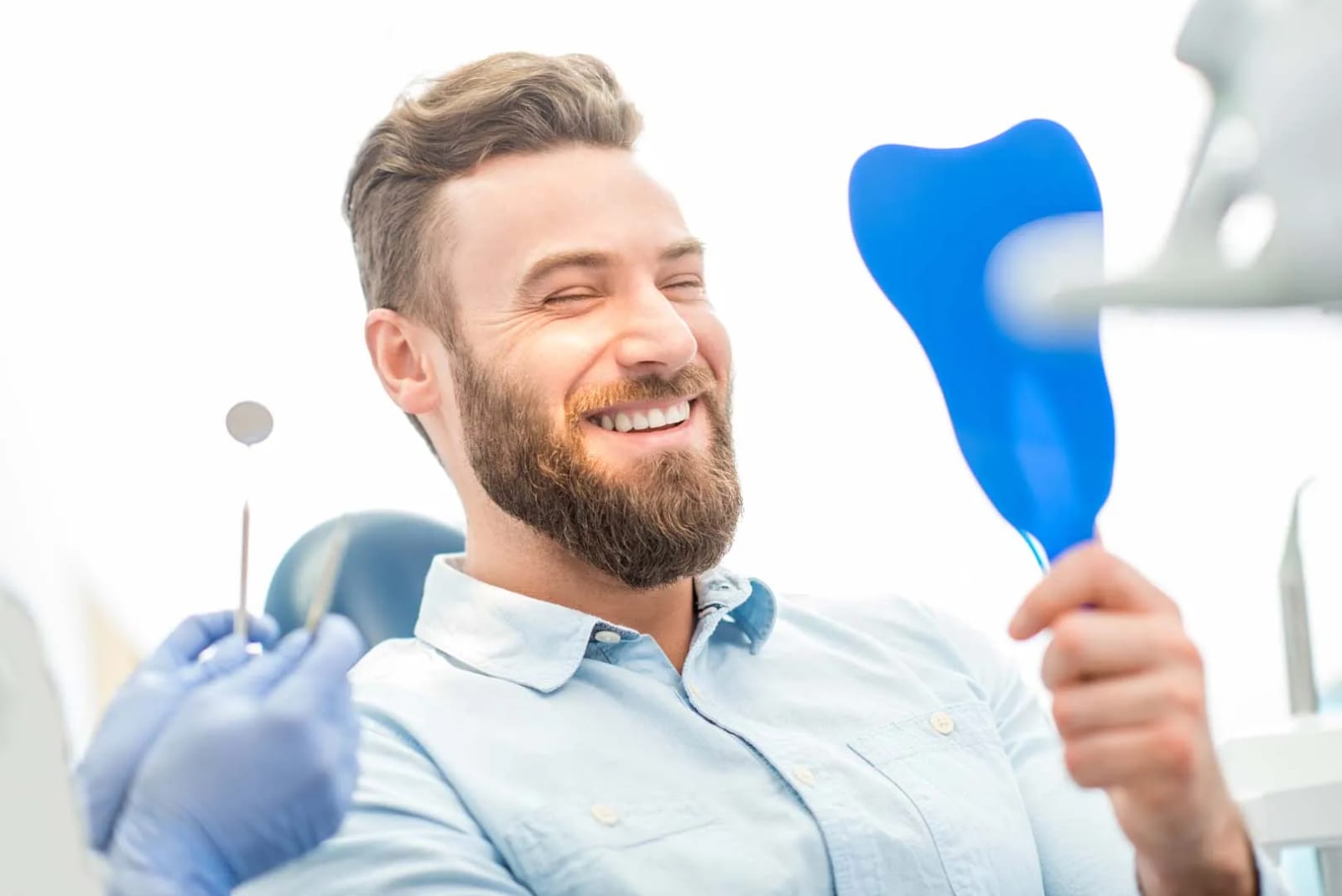 Smiling full-arch dental implant patient at Loudoun Valley Oral Surgery