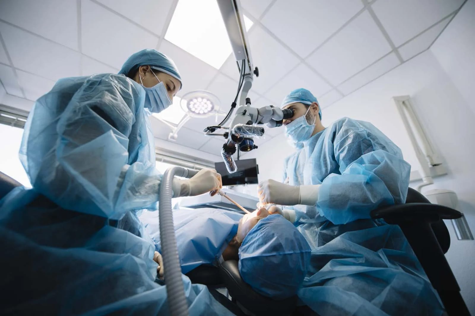 Oral surgeons performing a facial trauma surgical procedure